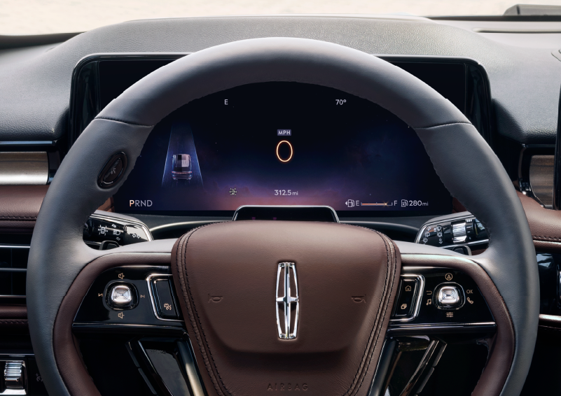 The steering wheel of 2025 Lincoln Aviator® SUV is shown with black and brown accents. | Joe Rizza Lincoln of Orland Park in Orland Park IL