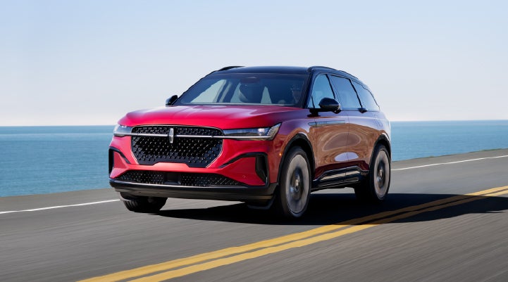 A 2025 Lincoln Nautilus® SUV is being driven on a seaside roadway. | Joe Rizza Lincoln of Orland Park in Orland Park IL