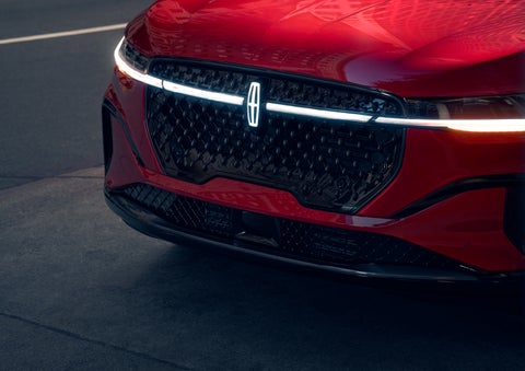 The available front LED light bar and center Lincoln Star logo glow at dusk. | Joe Rizza Lincoln of Orland Park in Orland Park IL
