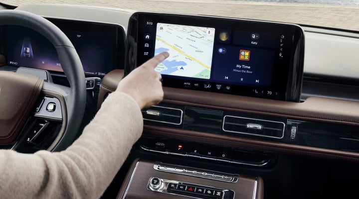 A person is tapping the center display touchscreen of a 2026 Lincoln Aviator® SUV. | Joe Rizza Lincoln of Orland Park in Orland Park IL