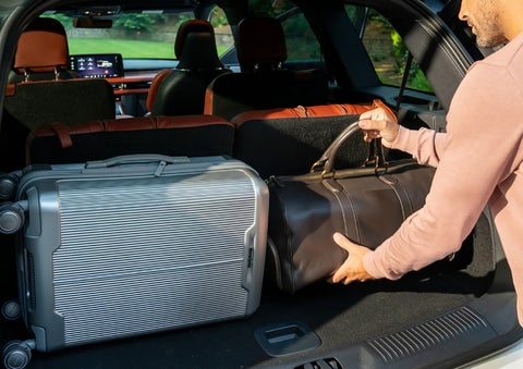A man loads luggage into the rear of a 2026 Lincoln Aviator® SUV through the opened rear liftgate. | Joe Rizza Lincoln of Orland Park in Orland Park IL