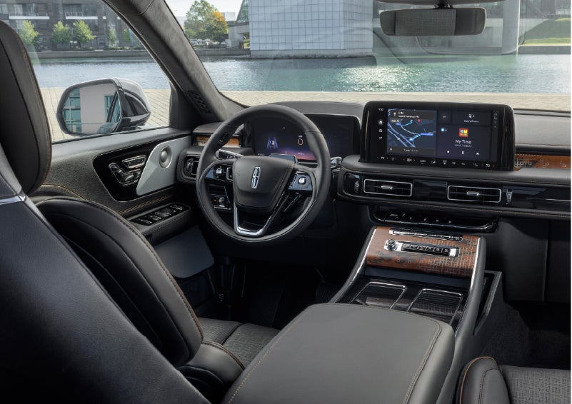 The interior of the 2026 Lincoln Aviator® SUV is shown parked with a view of a harbor through the windshield. | Joe Rizza Lincoln of Orland Park in Orland Park IL