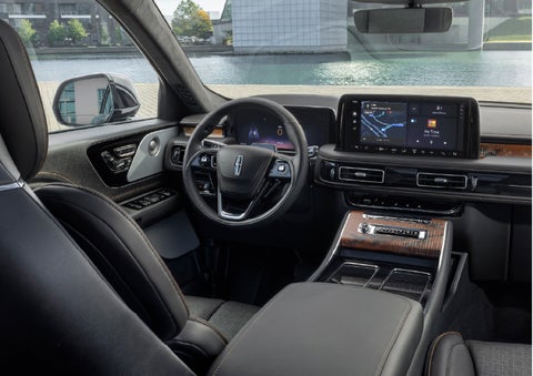 The interior of the 2026 Lincoln Aviator® SUV is shown parked with a view of a harbor through the windshield. | Joe Rizza Lincoln of Orland Park in Orland Park IL