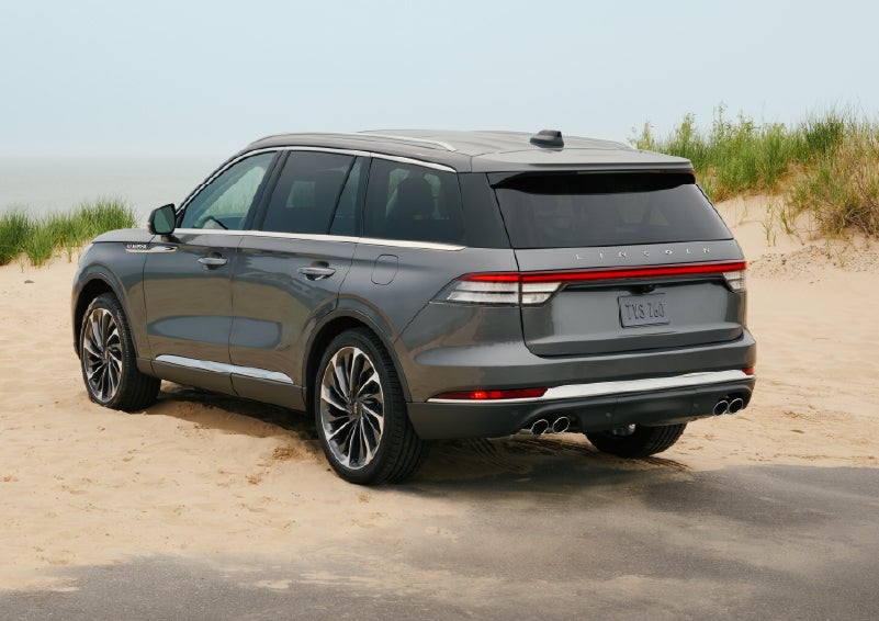 A 2027 Lincoln Aviator® SUV is parked next to sand dunes. | Joe Rizza Lincoln of Orland Park in Orland Park IL