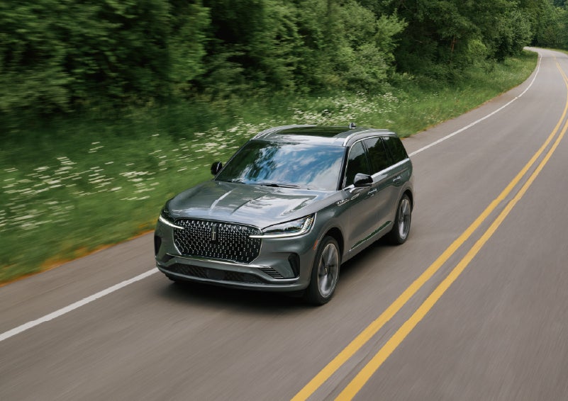 A 2027 Lincoln Aviator® SUV is being driven down a road. | Joe Rizza Lincoln of Orland Park in Orland Park IL