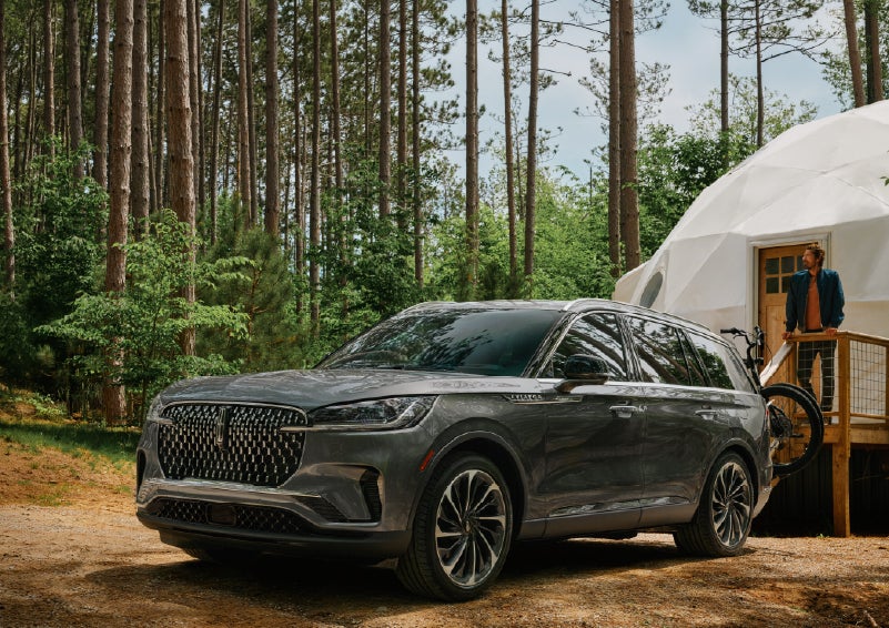 A 2027 Lincoln Aviator® is parked next to a high end glamping site. | Joe Rizza Lincoln of Orland Park in Orland Park IL