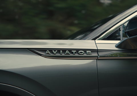 The driver’s side door and fender badging of a gray 2027 Lincoln Aviator® SUV are showcased. | Joe Rizza Lincoln of Orland Park in Orland Park IL