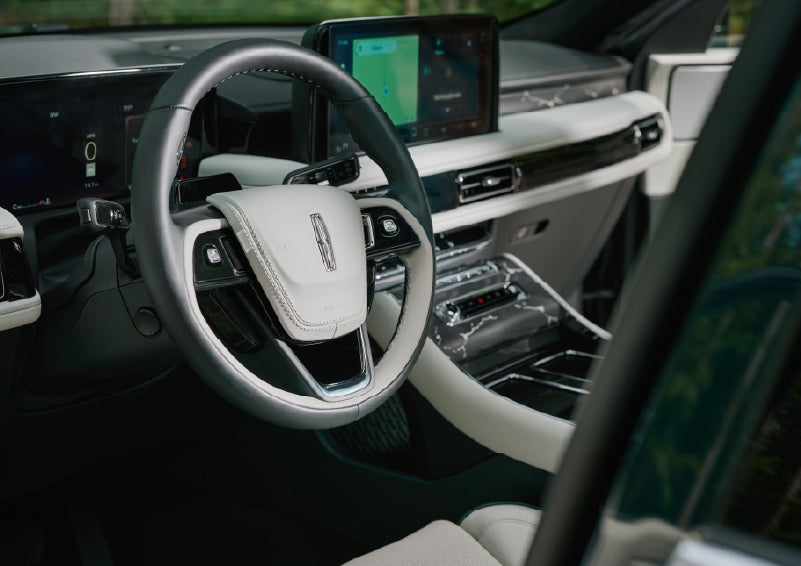 The leather-trimmed steering wheel of a 2027 Lincoln Aviator® Black Label™ SUV. | Joe Rizza Lincoln of Orland Park in Orland Park IL
