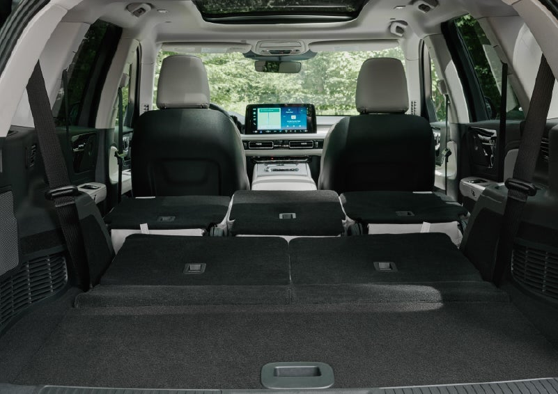 A rear to front view of the interior of a 2027 Lincoln Aviator® Black Label™ SUV shows the third and second rows folded flat | Joe Rizza Lincoln of Orland Park in Orland Park IL