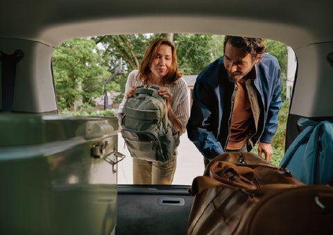 A couple loads luggage into the rear of a 2027 Lincoln Aviator® Black Label™ SUV..e 202 | Joe Rizza Lincoln of Orland Park in Orland Park IL